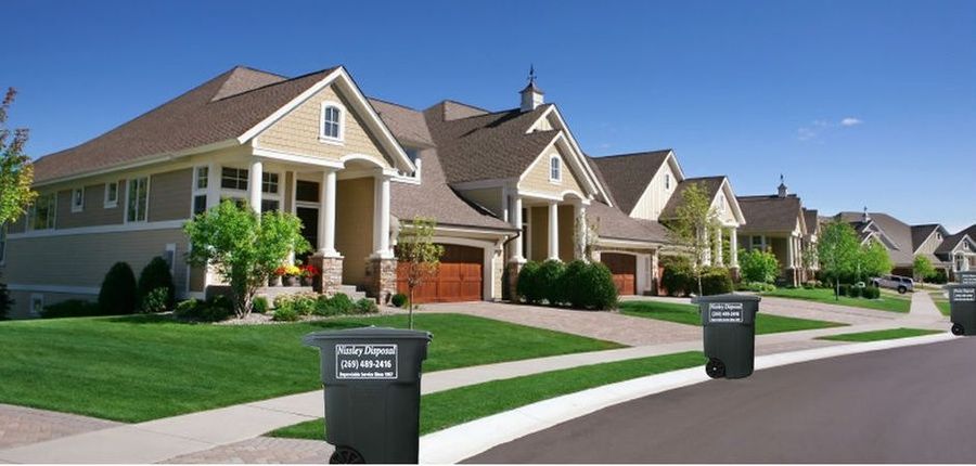 Image of houses with Nissley Disposal branded waste containers in front